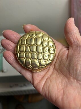 Vintage Estée Lauder gold compact.